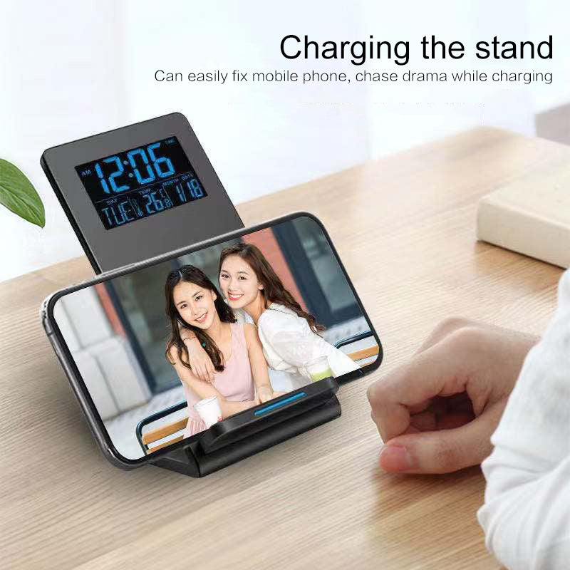 "Bedside alarm clock charging phone wirelessly with LED time display"