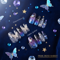 Celestial nail art bundle flat lay on navy velvet with star confetti and gems