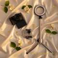 4K vlogging camera, action camera and selfie stick tripod on cream silk