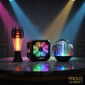 Three party speakers with colorful LED lights on dark marble